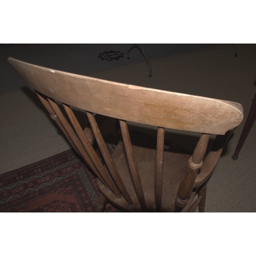 5 - An elm and beech farmhouse armchair, with spindle back, solid seat and splayed turned legs, 111cm hi... 