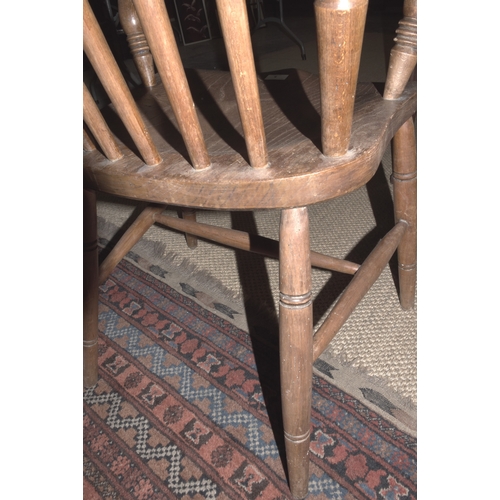 5 - An elm and beech farmhouse armchair, with spindle back, solid seat and splayed turned legs, 111cm hi... 