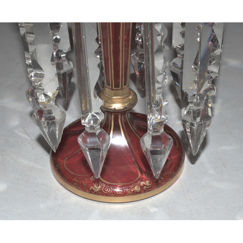 33 - A Continental red and gilt glass lustre vase decorated with vignettes of young women and flowers wit... 