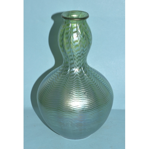 35 - An irridescent green glass vase, 23cm high, a circular clear glass match strike, other coloured glas... 