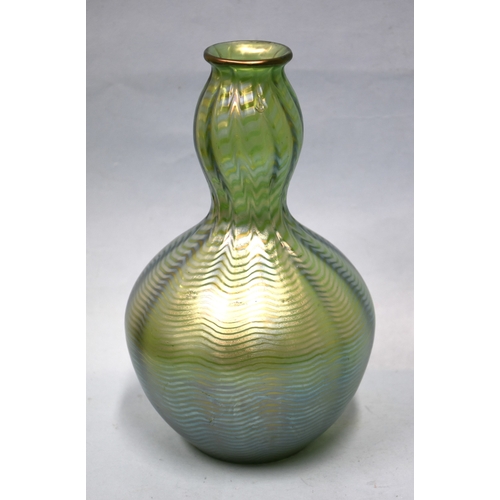 35 - An irridescent green glass vase, 23cm high, a circular clear glass match strike, other coloured glas... 