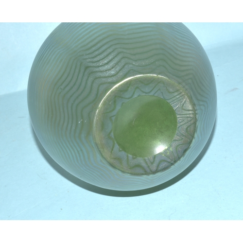 35 - An irridescent green glass vase, 23cm high, a circular clear glass match strike, other coloured glas... 