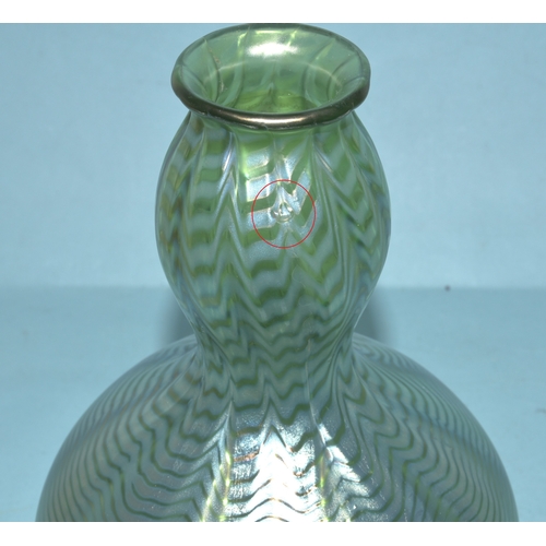 35 - An irridescent green glass vase, 23cm high, a circular clear glass match strike, other coloured glas... 