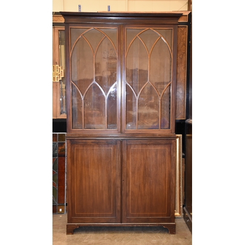 10 - A 19th century inlaid mahogany bookcase, having a pair of lancet-shaped astragal-glazed doors above ... 