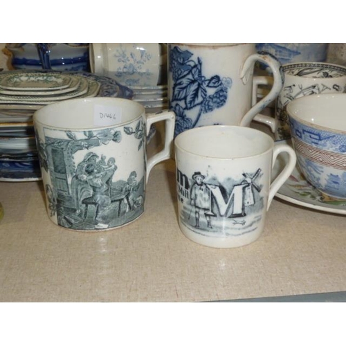 36 - A Victorian black and white transfer-printed ceramic mug decorated with the letter 'M' and prints of... 
