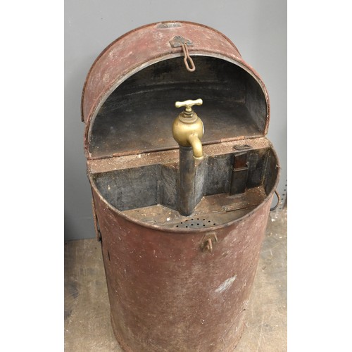 25 - An oil/paraffin drum dispenser, the hinged lid opening to reveal a brass pump and tap, with 