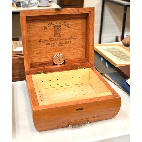 27 - A modern wooden humidor, 26 x 23cm, 12.5cm high, one other, and a small collection of unopened cigar... 