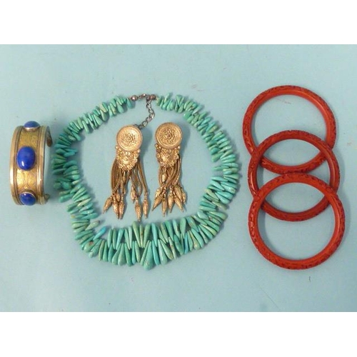 195 - A Turkmeni bangle set three sodalite cabochons, a pair of white metal Middle Eastern tasselled earri... 
