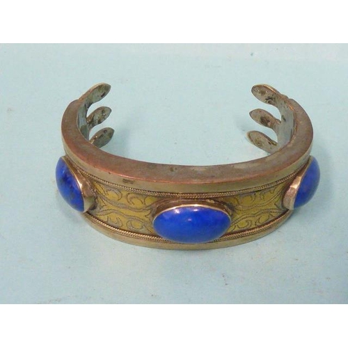 195 - A Turkmeni bangle set three sodalite cabochons, a pair of white metal Middle Eastern tasselled earri... 
