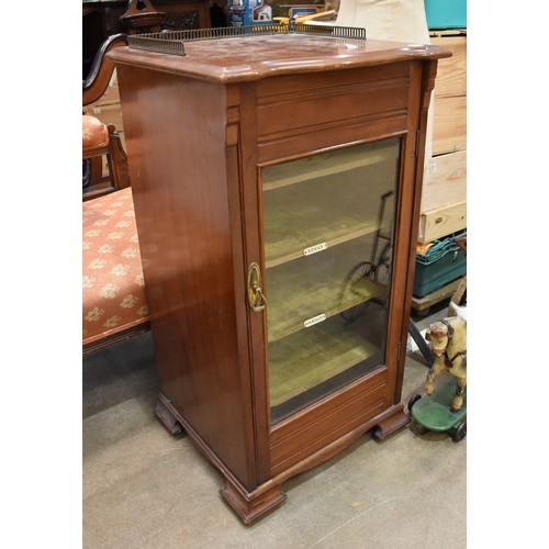 2 - An Edwardian mahogany music cabinet, the shaped top with brass pierced gallery, above a single glaze... 