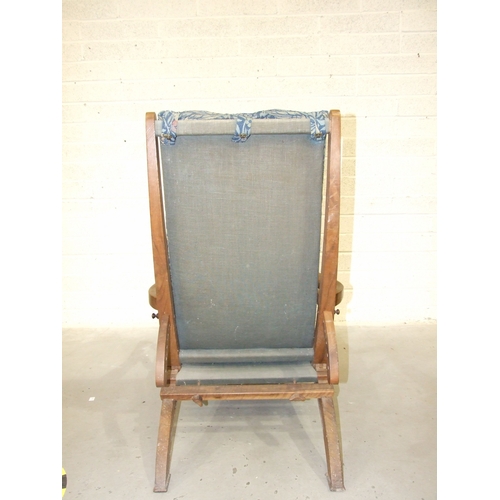 63 - Arthur Romney Green, a walnut reclining chair with adjustable back rest, shaped original open arms a... 