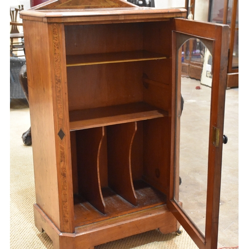 51 - A Victorian walnut cross-banded music cabinet, the glass door enclosing a fitted interior, 59cm wide... 