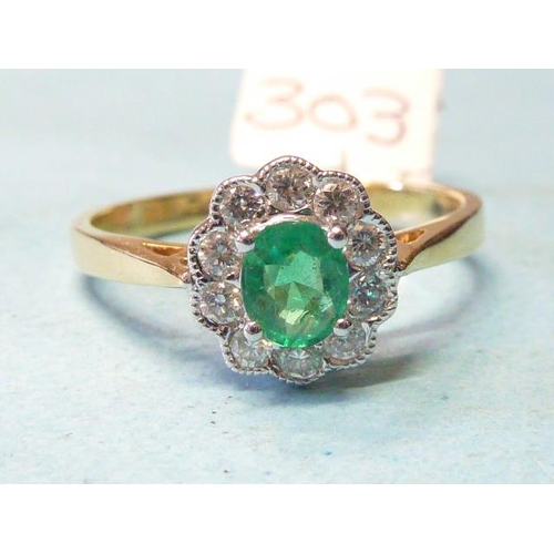 303 - An emerald and diamond cluster ring, claw-set an oval emerald within a border of ten brilliant-cut d... 