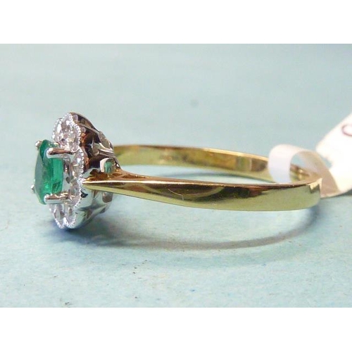 303 - An emerald and diamond cluster ring, claw-set an oval emerald within a border of ten brilliant-cut d... 