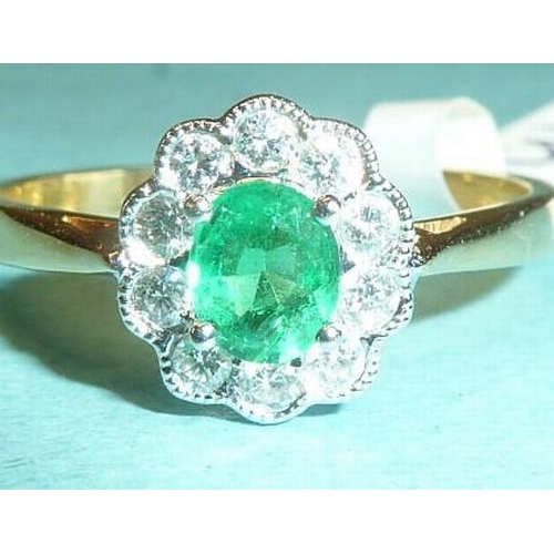 303 - An emerald and diamond cluster ring, claw-set an oval emerald within a border of ten brilliant-cut d... 