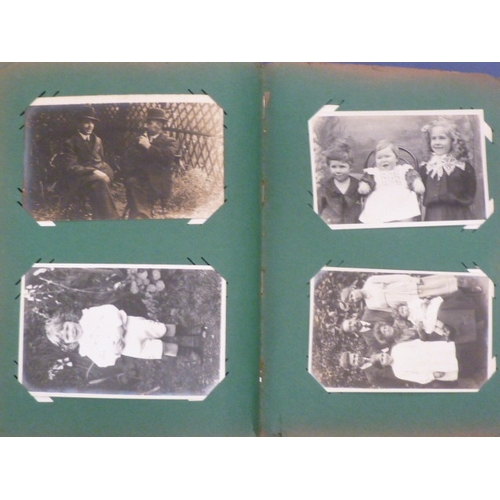 47 - An album of approximately 230 mainly photographic portraits, many with postcard backs, early-20th ce... 