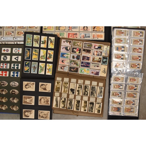 56 - A large collection of cigarette and trade cards, sets and part-sets, contained in loose-leaf albums ... 