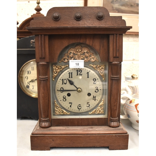18 - A mahogany case striking mantel clock with silvered dial, the top with three acorn finials, 49cm hig... 