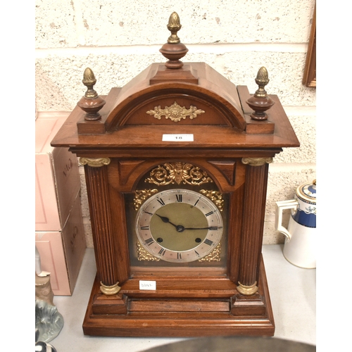 18 - A mahogany case striking mantel clock with silvered dial, the top with three acorn finials, 49cm hig... 