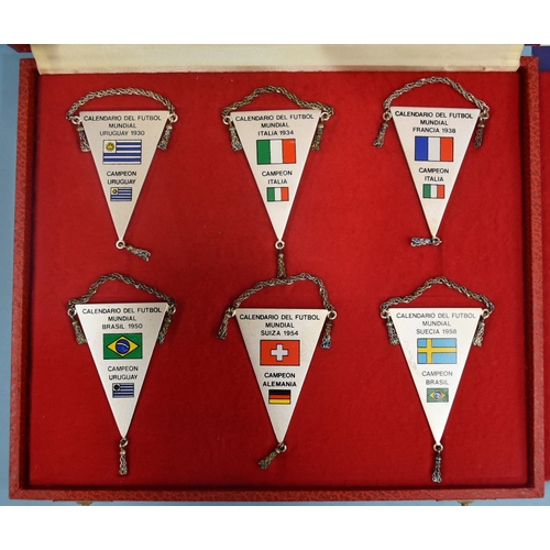 52 - A set of twelve white metal football pennants commemorating the World Cup hosts and winners 1930-198... 