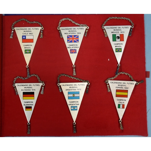 52 - A set of twelve white metal football pennants commemorating the World Cup hosts and winners 1930-198... 