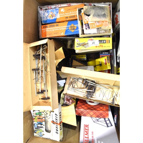37 - A large quantity of OO gauge railway layout buildings, station accessories and modelling materials.... 