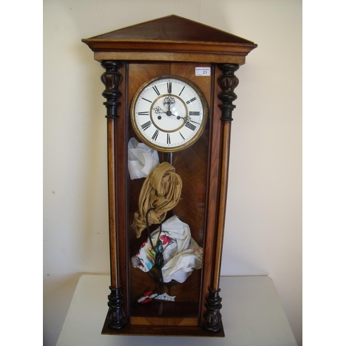 21 - Walnut cased double weighted Vienna style wall clock with white enamel dial