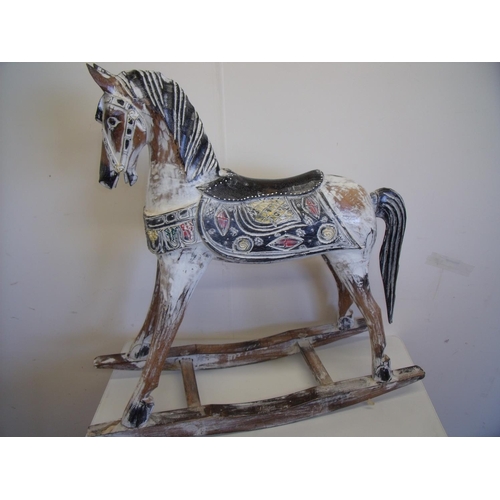 27 - Carved wood rocking horse with painted detail (76cm high)
