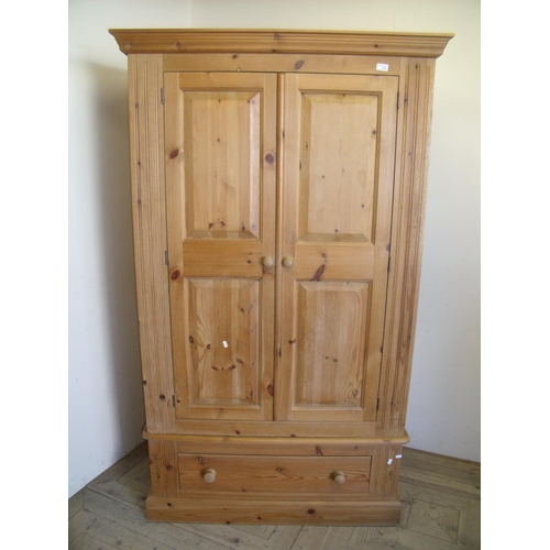 378 - Moreland pine quality two door wardrobe with drawer to the base (width 107cm)