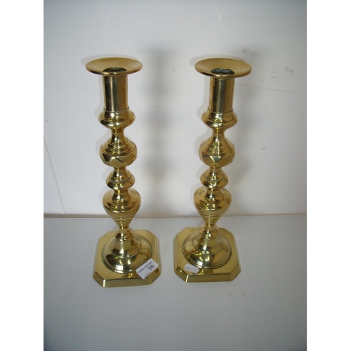 58 - Large pair of brass candlesticks on turned columns and square push bases (35cm high)