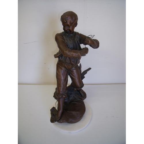 35 - Early-mid 20th C spelter figure of a boy fishing, on turned marble base (36cm high)
