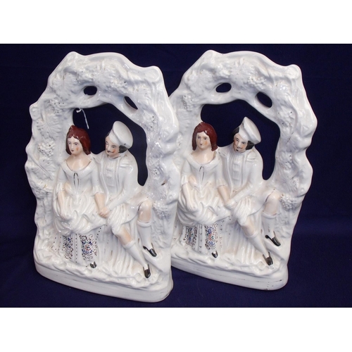18 - Pair of Staffordshire figures depicting Scottish seated courting couple (36cm high)
