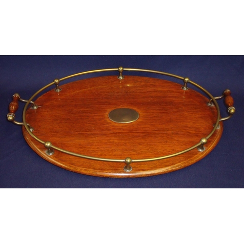 45 - Edwardian oak oval serving tray with brass galley and twin handles with central cartouche on four ra... 