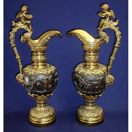 46 - Large pair of bronze ewer garnitures, the central body depicting classical scenes of frolicking cher... 