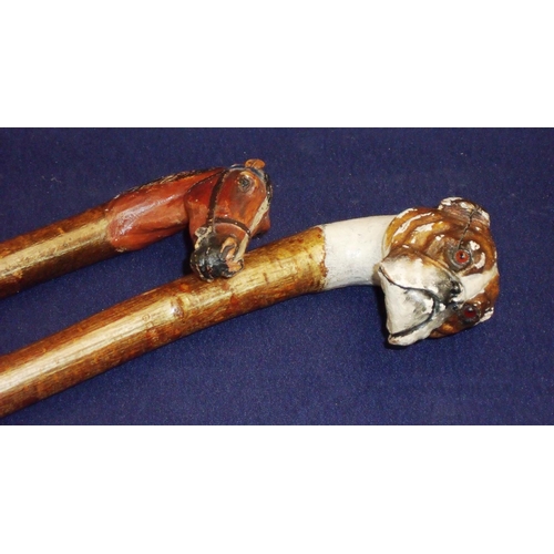 49 - Two carved wood and painted walking sticks, one with handle in the from of a bulldog, the other of a... 