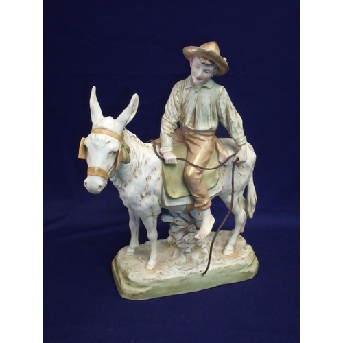6 - Royal Dux figure No 1989 of a boy riding a donkey with impressed marks and Royal Dux triangle to the... 