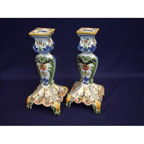 7 - Pair of continental tin glazed candlesticks with square tops and raised square bases, with elaborate... 