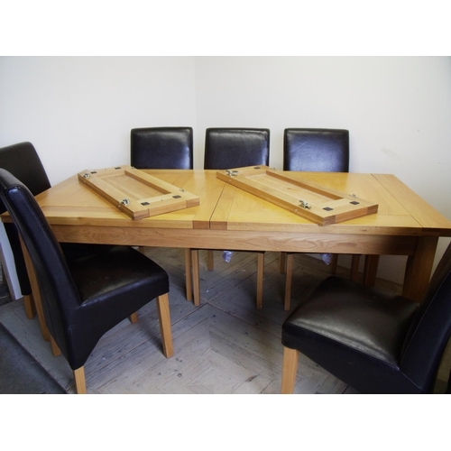 379 - Modern light oak extending dining table and a set of six leather dining chairs (minimum length 204cm... 