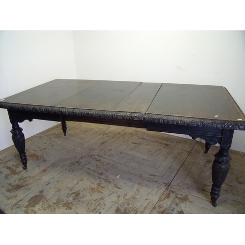 383 - Victorian dark oak extending dining table with two additional leaves and carved border detail, on tu... 