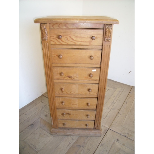 399 - Pine seven drawer Wellington chest with carved detail (51cm x 36cm x 105cm)