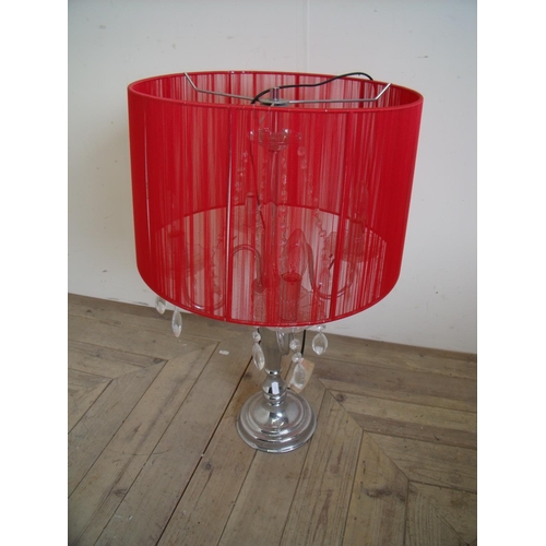 103 - Modern silver plated four branch table lamp with red shade and cut glass sconces with drops