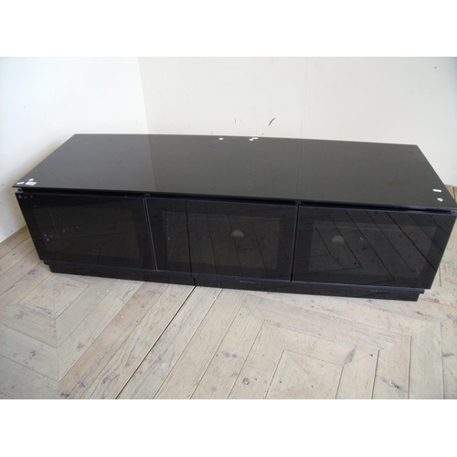 359 - Modern smoked glass lounge unit enclosed by three glazed cupboard doors (150cm x 50cm x 43xm)