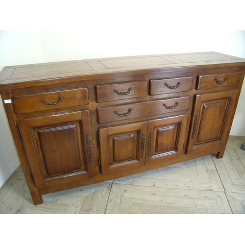 392 - Quality heavy oak sideboard with four drawers above central drawer and four panelled cupboard doors ... 