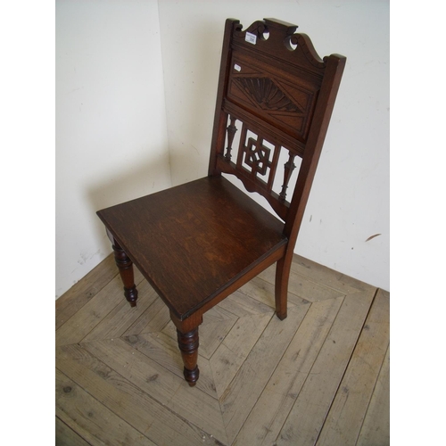 396 - Victorian oak hall chair with carved panelled back above solid seat and turned supports