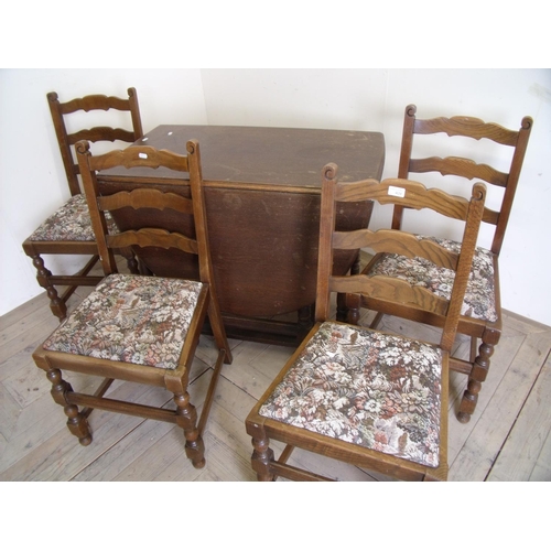 409 - Oak drop leaf gate leg table on turned supports and a set of four ladder back chairs with drop-in up... 