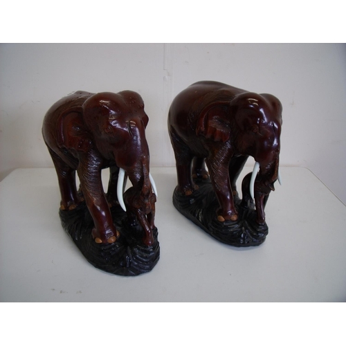 49 - Pair of carved hardwood figures of elephants with calf (25cm high)
