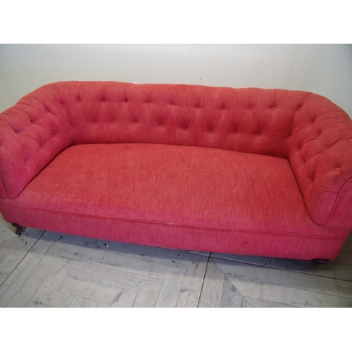 213 - Upholstered Chesterfield style two seat sofa on turned front supports the rear leg stamped Howard (1... 