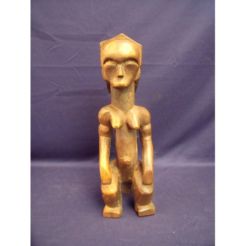 36 - Carved wood African tribal figure of a seated female (31cm high)