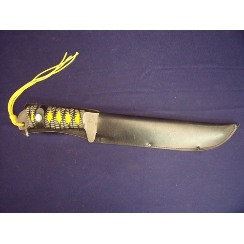 46 - Large bladed knife with woven material grip, with 10.5 inch toothpick blade with serrated top with i... 