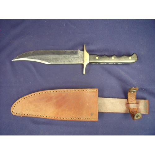 66 - Damascus steel bladed Bowie type knife with 6.5 inch blade brass cross piece and two piece wooden gr... 